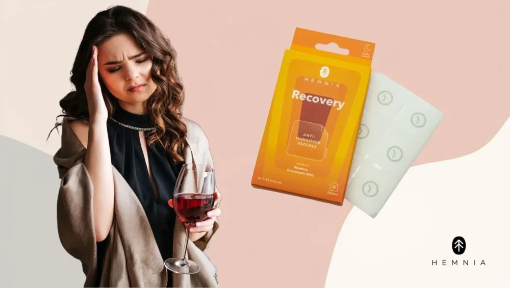 En kvinde med et glas vin på hovedet ved siden af sine Hemnia Recovery-plastre til at komme sig efter festen